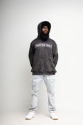 Black acid-wash oversized cotton hoodie with embroidered HIGHERself logo, arm pocket, and kangaroo pocket by Soul Seed Apparel, sizes S–3XL