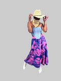 Model wearing Black Herstory midi skirt with purple portrait collage print and flared hem